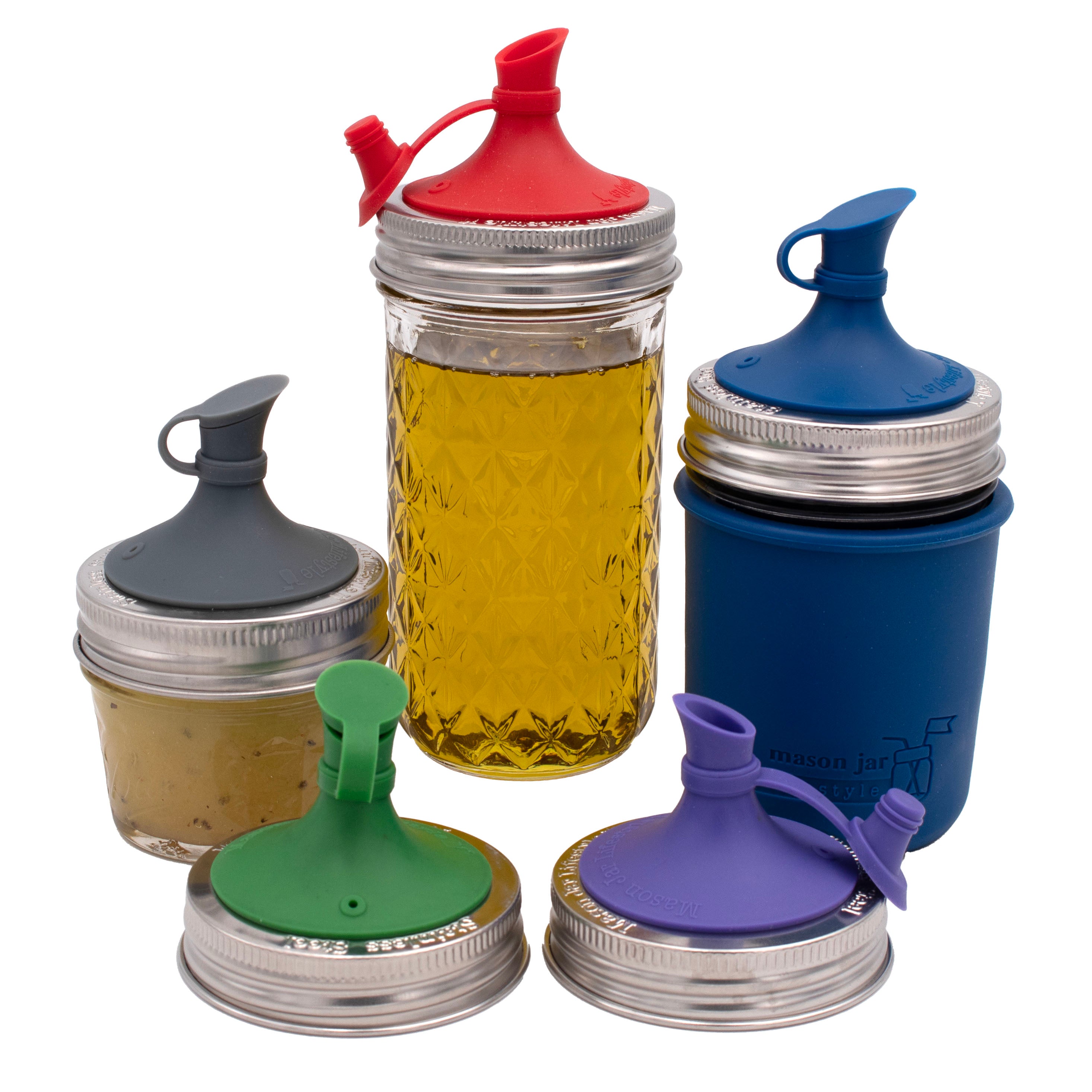 Silicone oil cruet lid for Mason jars on three different sizes of regular mouth Mason jars.