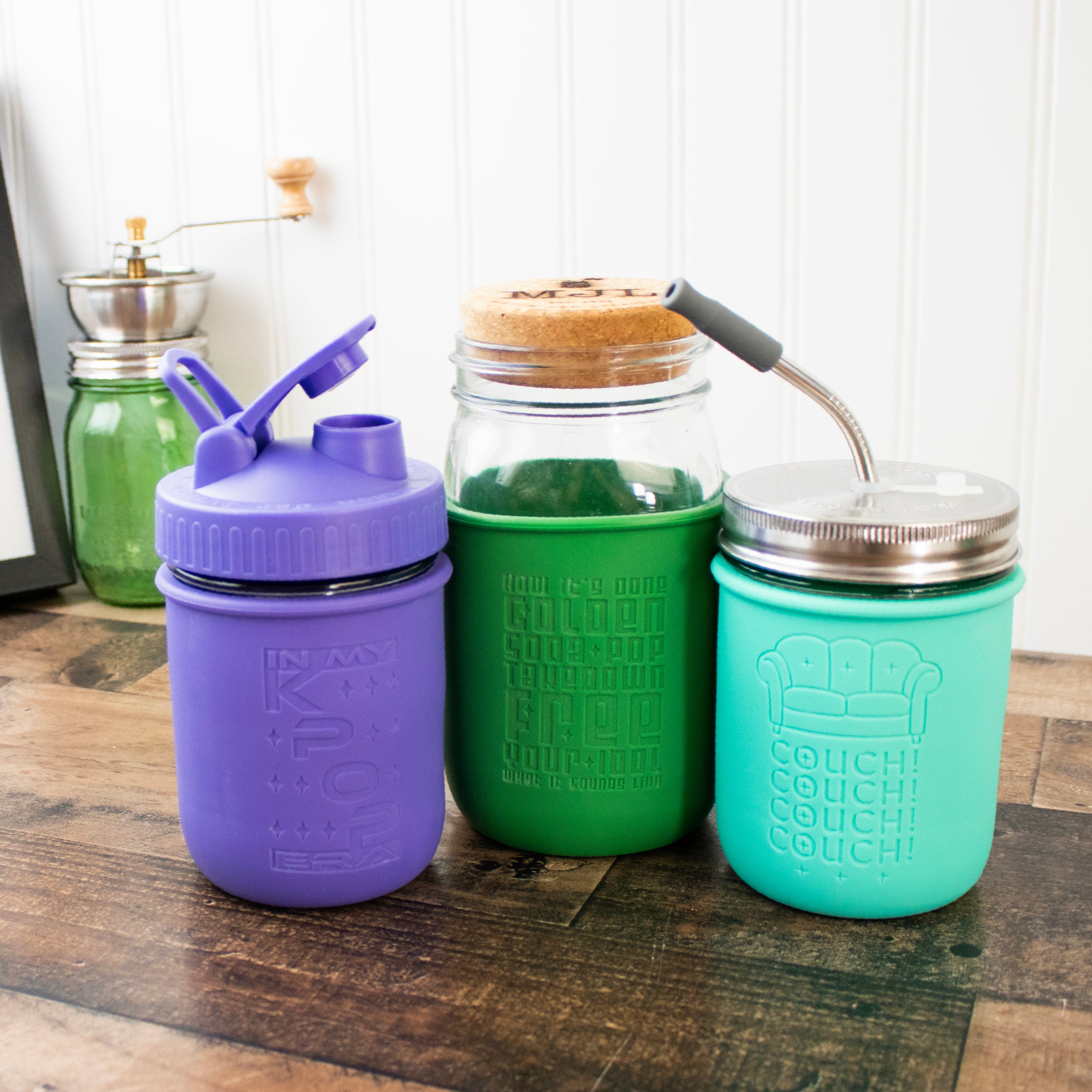 Example of the Mason jar engraved sleeves on quart sleeves and wide mouth sleeves, with pour and store lid, cork lid, and stainless steel straw hole lid with straw.