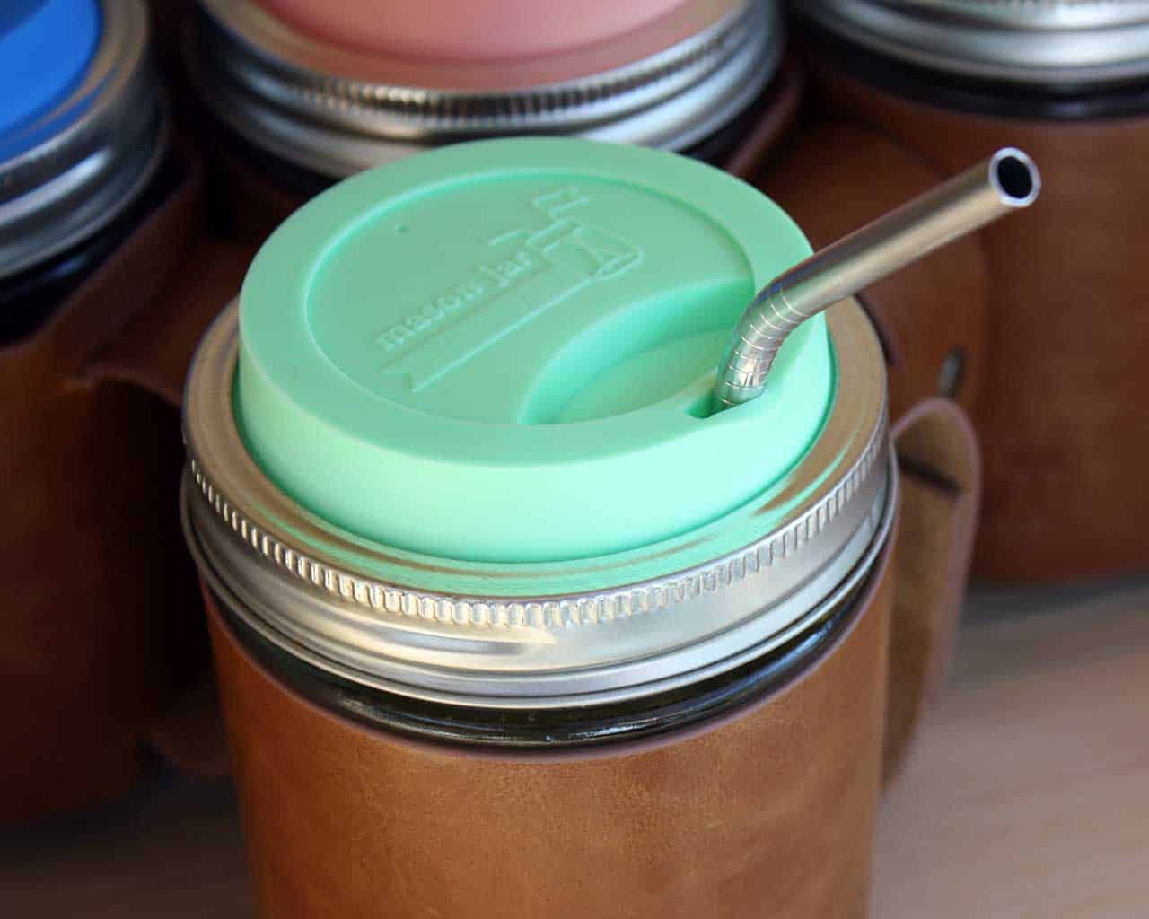 Thin bent stainless steel straw for pint Mason jars with mint green silicone drinking lid
