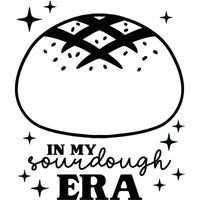 A black and white graphic for laser engraving: A loaf of bread with scoring and seeds on top, with text on the bottom saying "In my sourdough era", with sparkles around it.