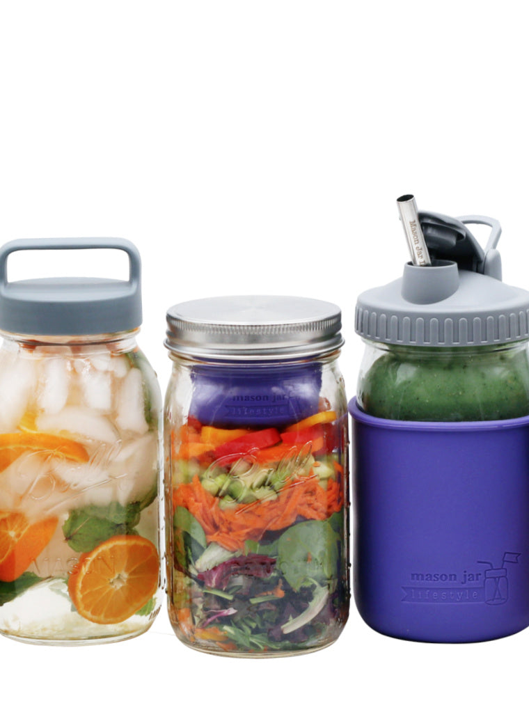 regular mouth gray plastic handle lid, wide mouth stainless steel storage lid, wide mouth gray pour and store lid, wide mouth ultra violet divider cup, long stainless steel straw, ultra violet 32oz quart silicone sleeve on regular and wide mouth quart jars with citrus ice water colorful salad and a green smoothie