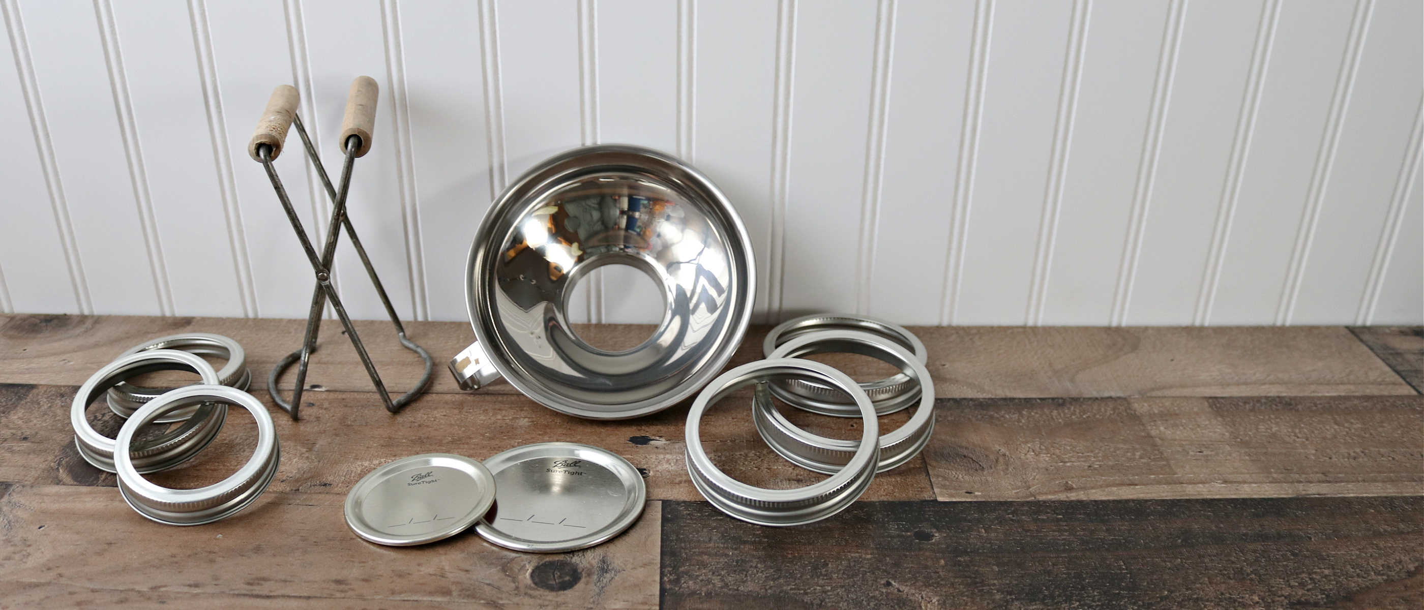 regular and wide mouth tin bands and flat lids, stainless steel canning funnel, and ball jar lifter
