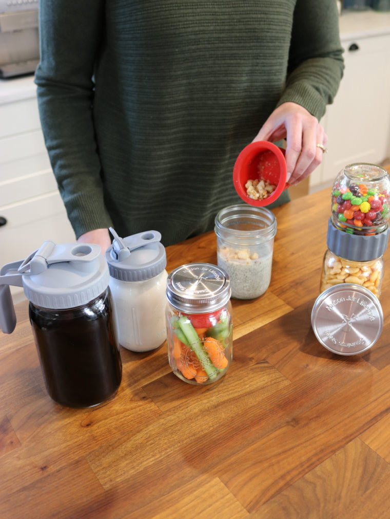 salad and snack starter gift set with regular and wide mouth pour and store lids, regular and wide mouth silicone divider cups and stainless steel storage lids, and 2 in 1 connector lid