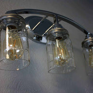 Light fixture with three quart cut bottom Ball Mason jars, wide mouth lighting lids, and LED Edison bulbs