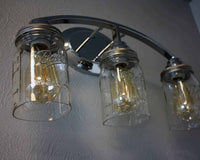 Light fixture with three quart cut bottom Ball Mason jars, wide mouth lighting lids, and LED Edison bulbs