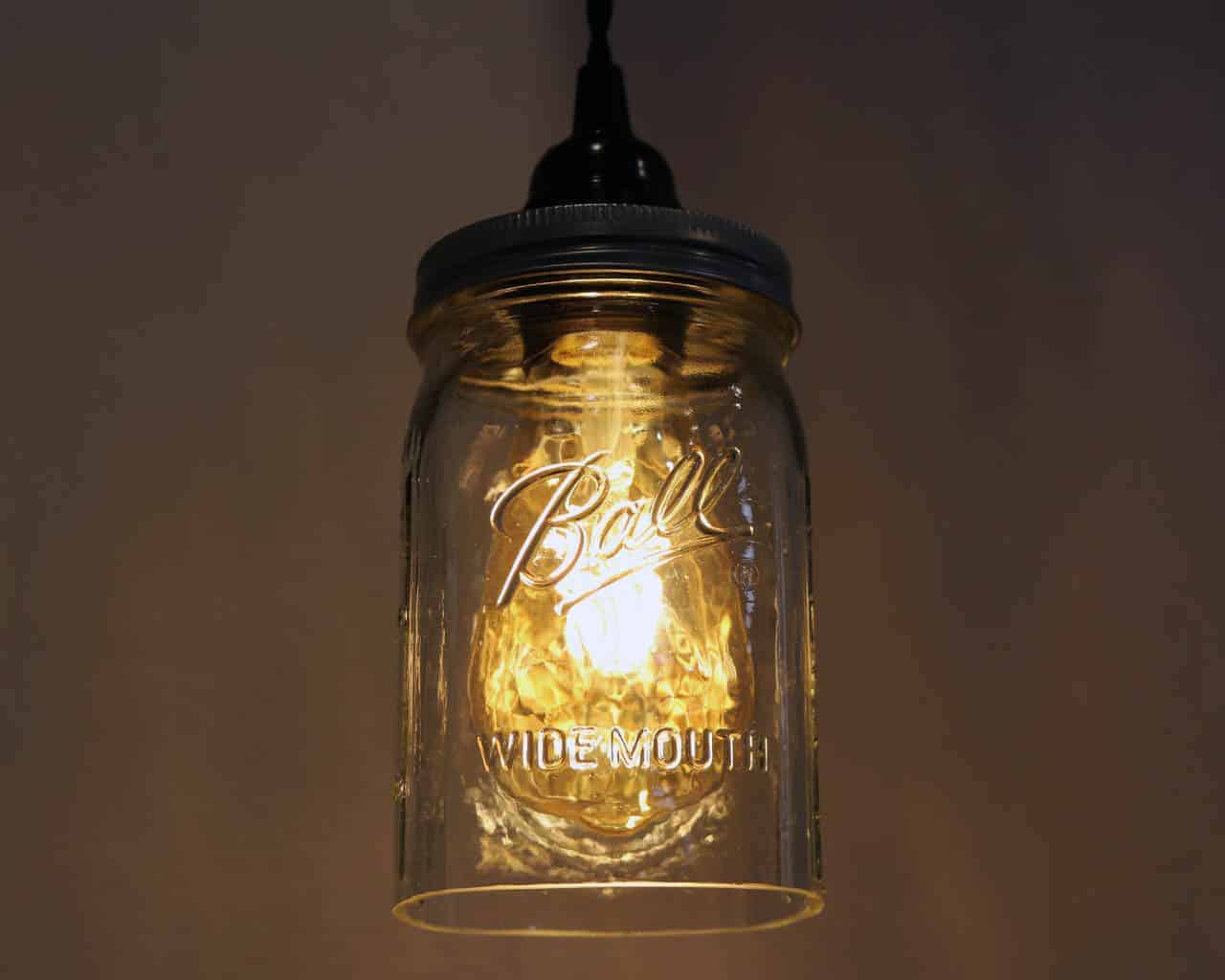 Ball wide mouth quart Mason jar pendant light full kit with hand cut jar, lid, on/off switch, and wall plug - bulb on