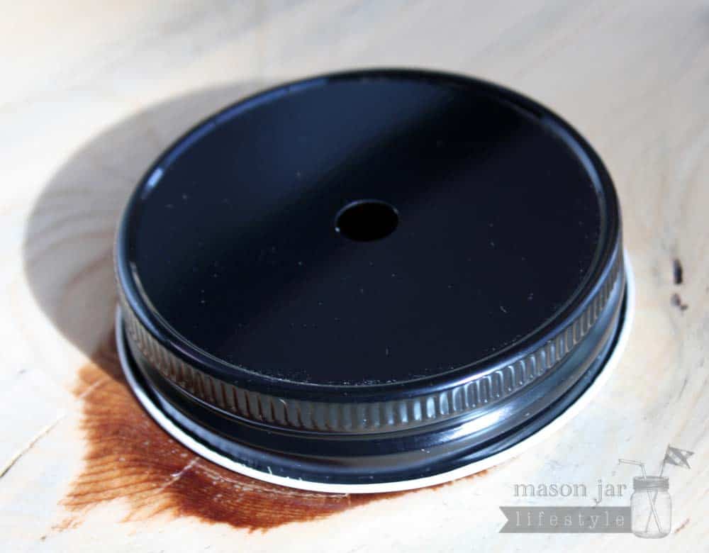 Black straw hole lid for regular mouth Mason jars side view