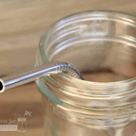 Close up of threading on short thin bent stainless steel straws for half pint Mason jars