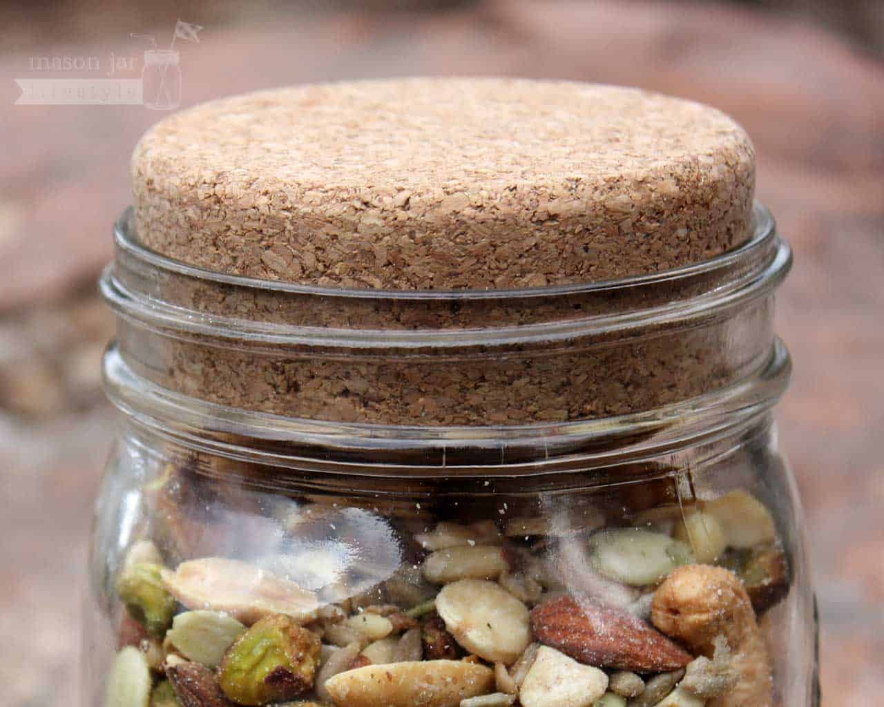 Cork lid stopper on wide mouth quart Kerr Mason jar with nuts