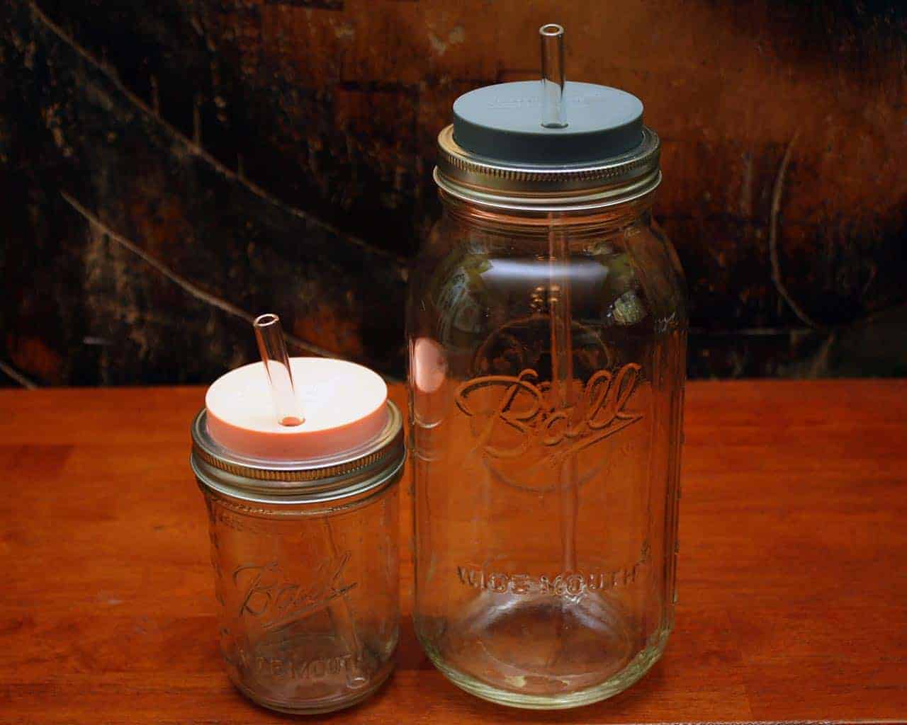Extra long thick glass straw in half gallon 64oz Mason jar and medium glass straw in pint 16oz Mason jar