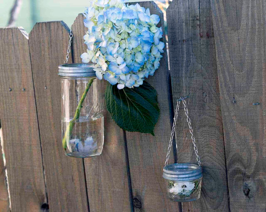 galvanized-metal-band-ring-with-chain-hanging-handle-regular-wide-mouth-mason-jars-flowers-fence