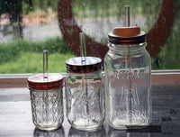 Thick glass smoothie straws in half pint, pint, and quart Ball Mason jars with lids