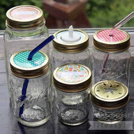 Gold rings / bands on six Ball Mason jars with different lid inserts