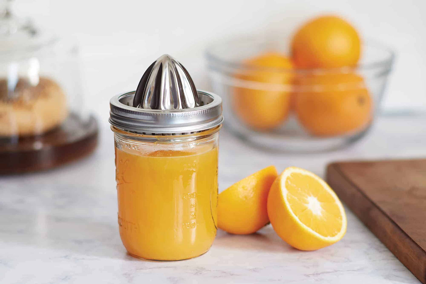 Jarware stainless steel juicing lid on wide mouth pint Mason jar with lemon juice