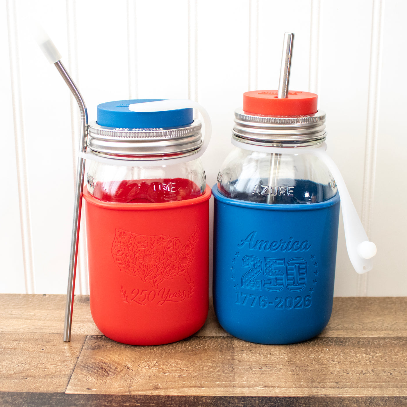 A Mason jar quarts with lids, straws, and straw straps, and the 250 anniversary sleeve designs.