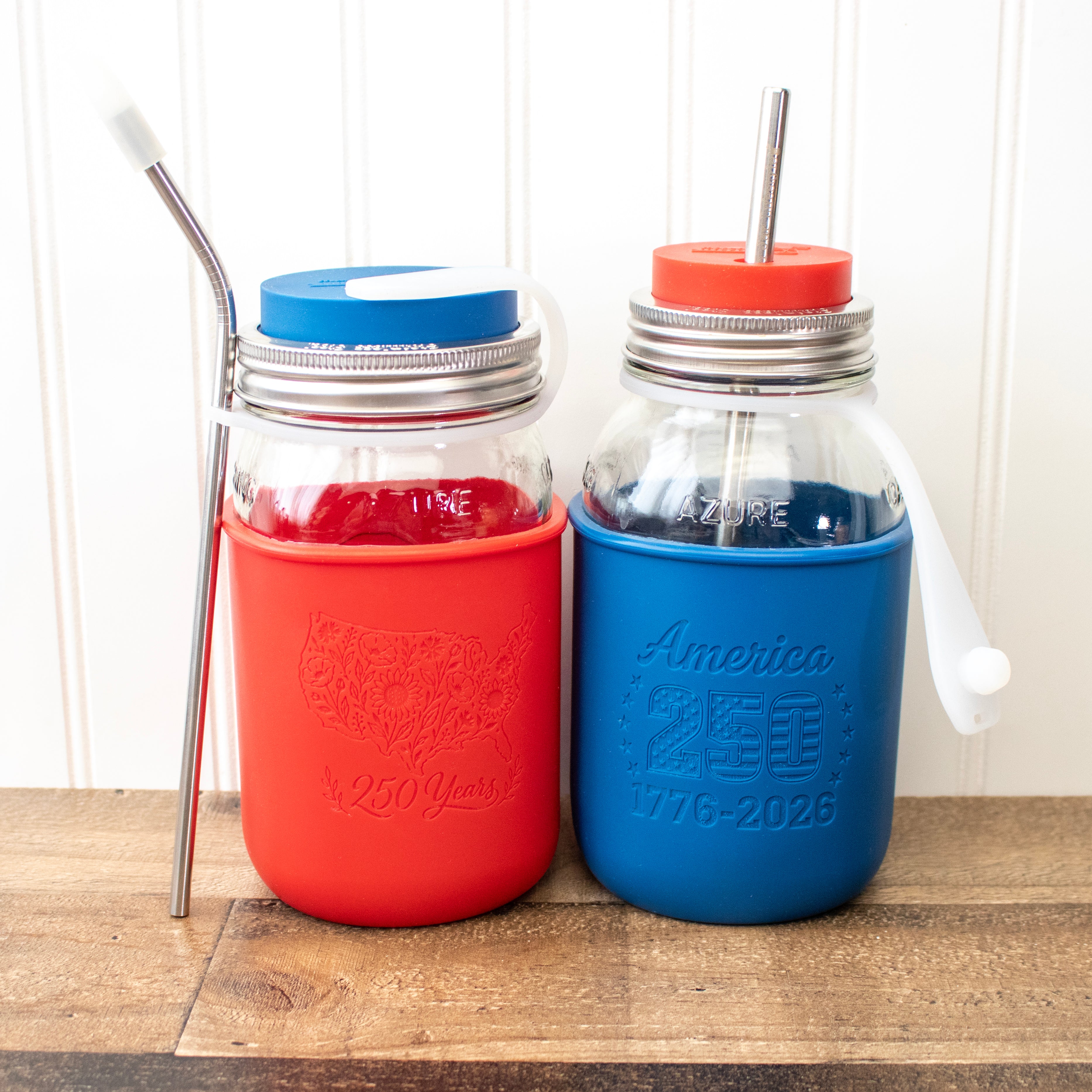 A Mason jar quarts with lids, straws, and straw straps, and the 250 anniversary sleeve designs.