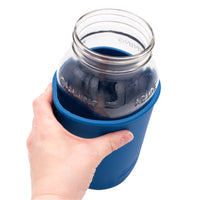 A closer shot of the sleeve on the jar, with a person squeezing the sleeve a bit, to show off the gap, which is about an inch.