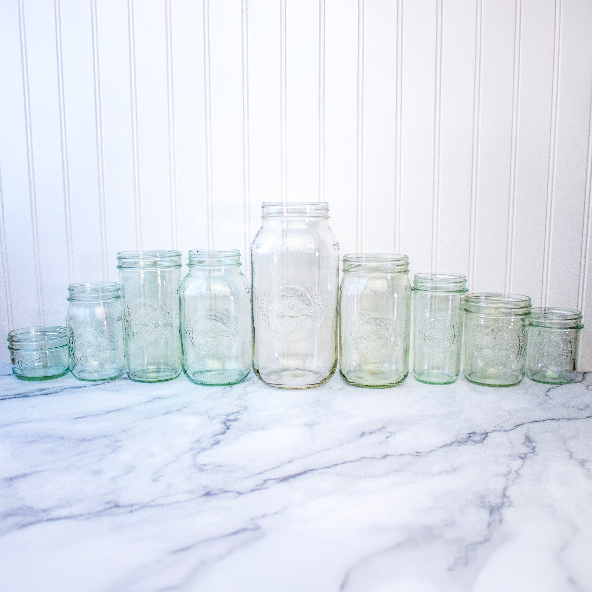A line up of all current Azure Mason jars we have available, the Half Gallon size being the largest, and the 8oz jars being the smallest.