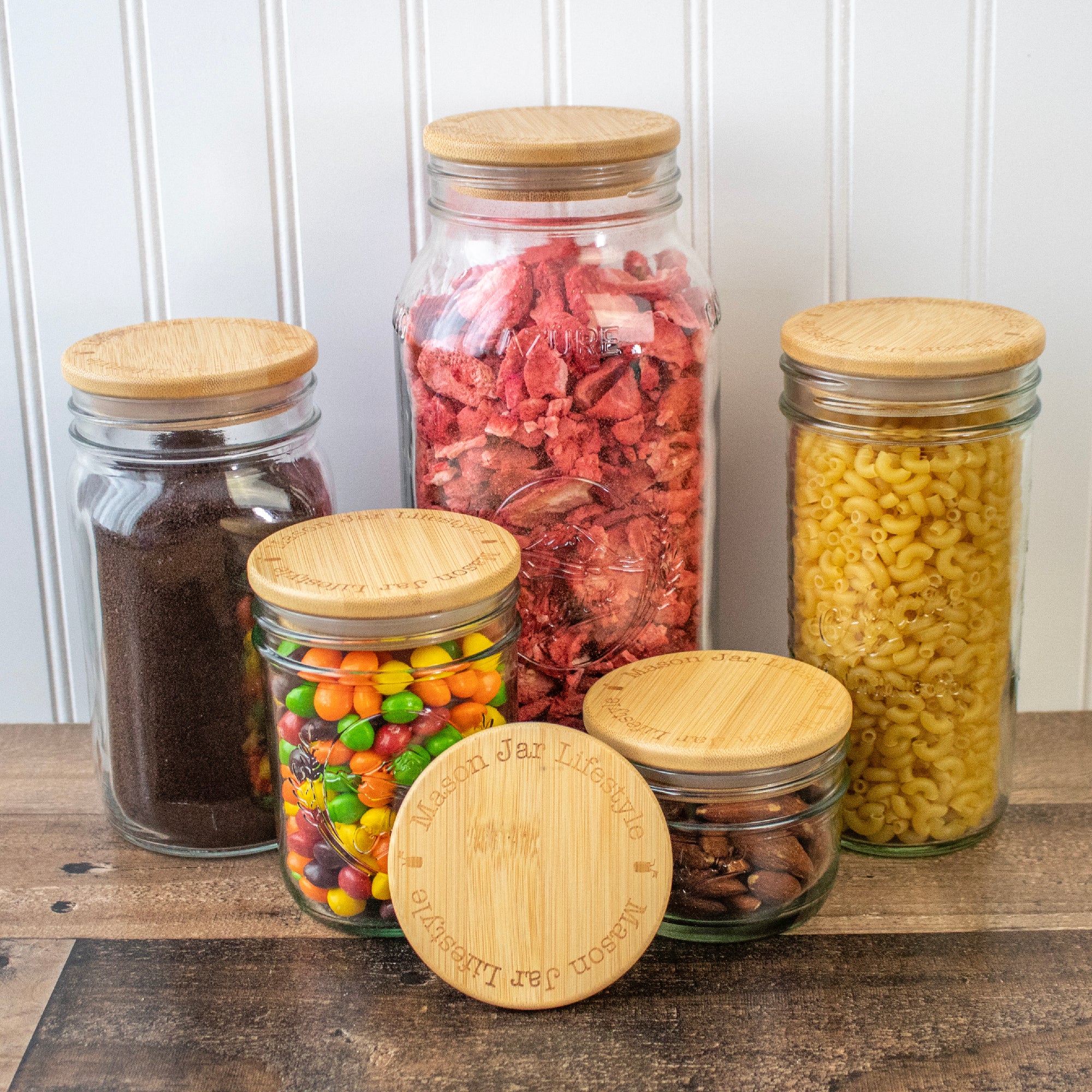 Wide mouth Mason jars with bamboo storage lids: 8oz, 16oz, 16oz, 24oz, 32oz, and 64oz jars.