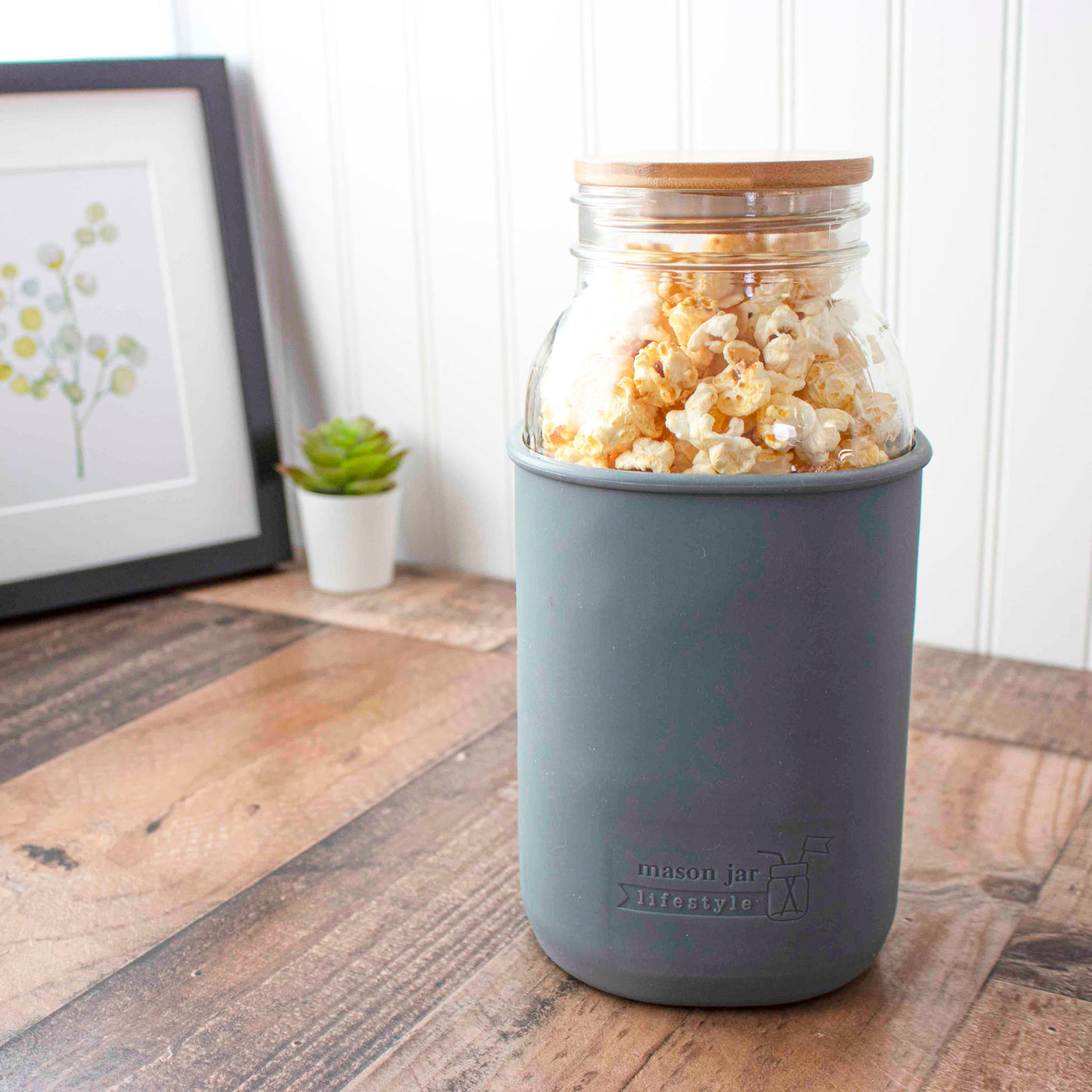 https://masonjarlifestyle.com/cdn/shop/files/mason-jar-lifestyle-charcoal-gray-silicone-sleeve-half-gallon-64oz-wide-mouth-ball-bamboo-storage-stopper-lid-staged.jpg?v=1700382030&width=1400