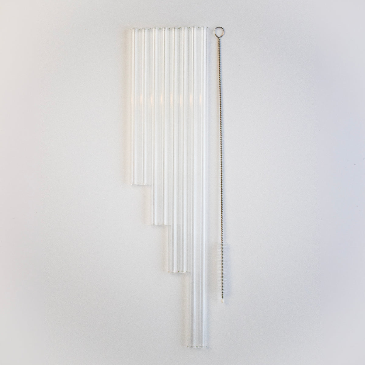 The 8 pack combo of 2 short, 2 medium, 2 long, 2 extra long straws, and a straw cleaner, on a green background.