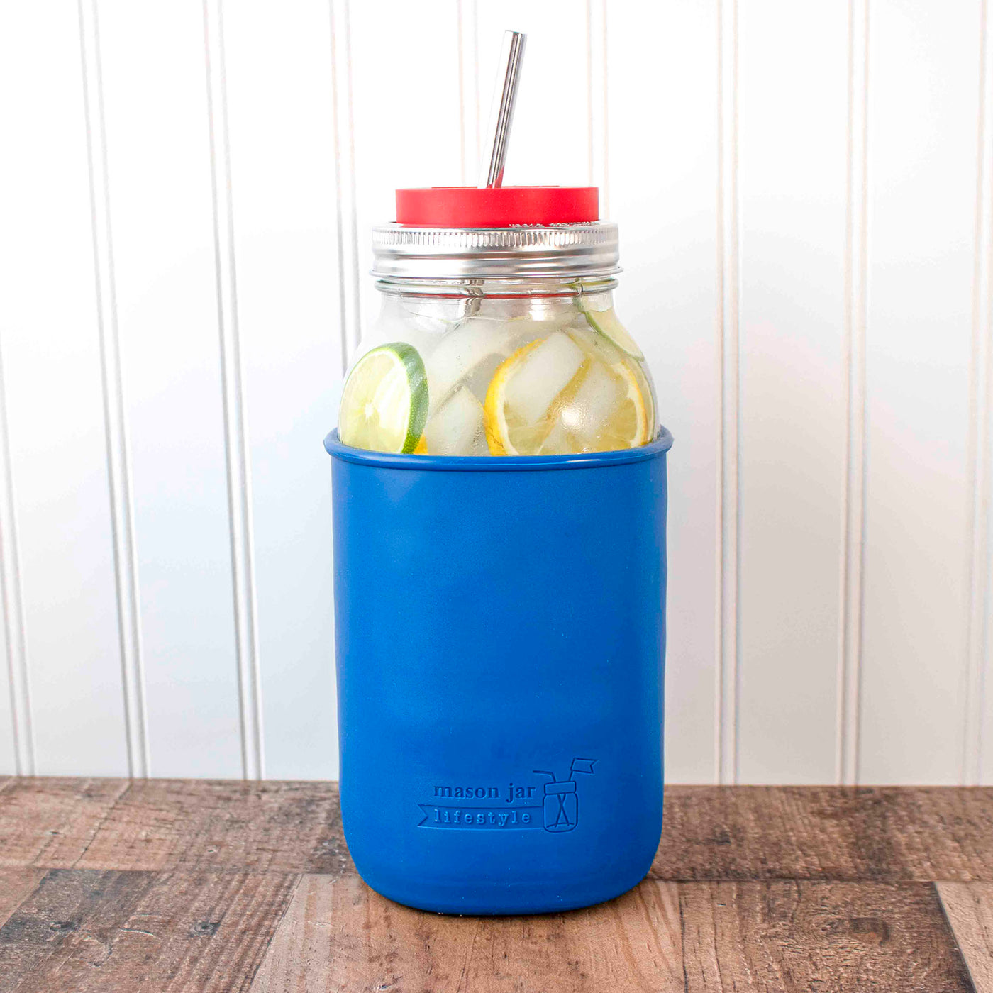 https://masonjarlifestyle.com/cdn/shop/files/mason-jar-lifestyle-deep-blue-silicone-sleeve-half-gallon-64oz-wide-mouth-ball-cherry-red-straw-hole-tumblr-long-straight-safer-stainless-steel-straw-staged-2.jpg?v=1700382030&width=1400