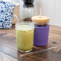 Short glass straws in regular mouth 8oz Mason jars, one with a silicone straw hole lid.