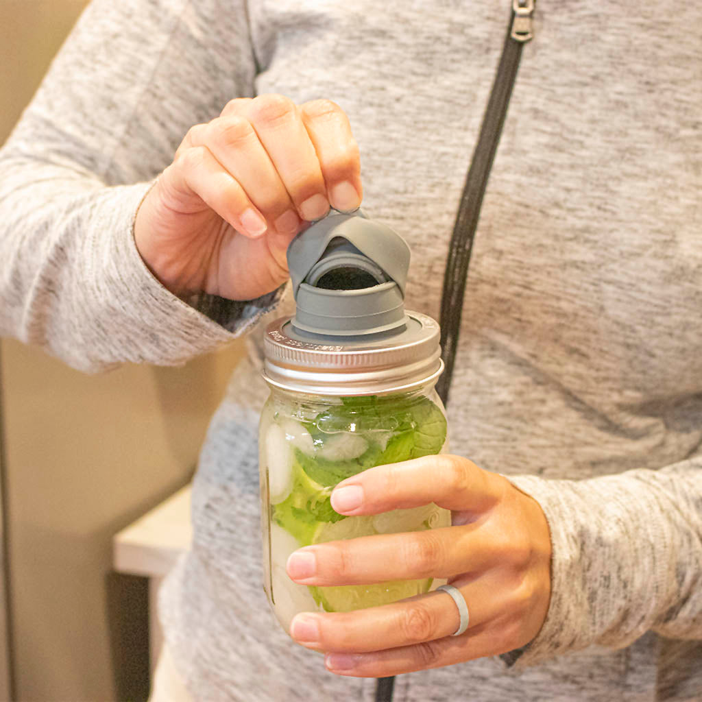 A hand pulling off the top of the chug lid, revealing the double layered silicone seal around the inside and outside, ensuring a leak proof seal.