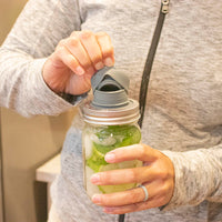 A hand pulling off the top of the chug lid, revealing the double layered silicone seal around the inside and outside, ensuring a leak proof seal.