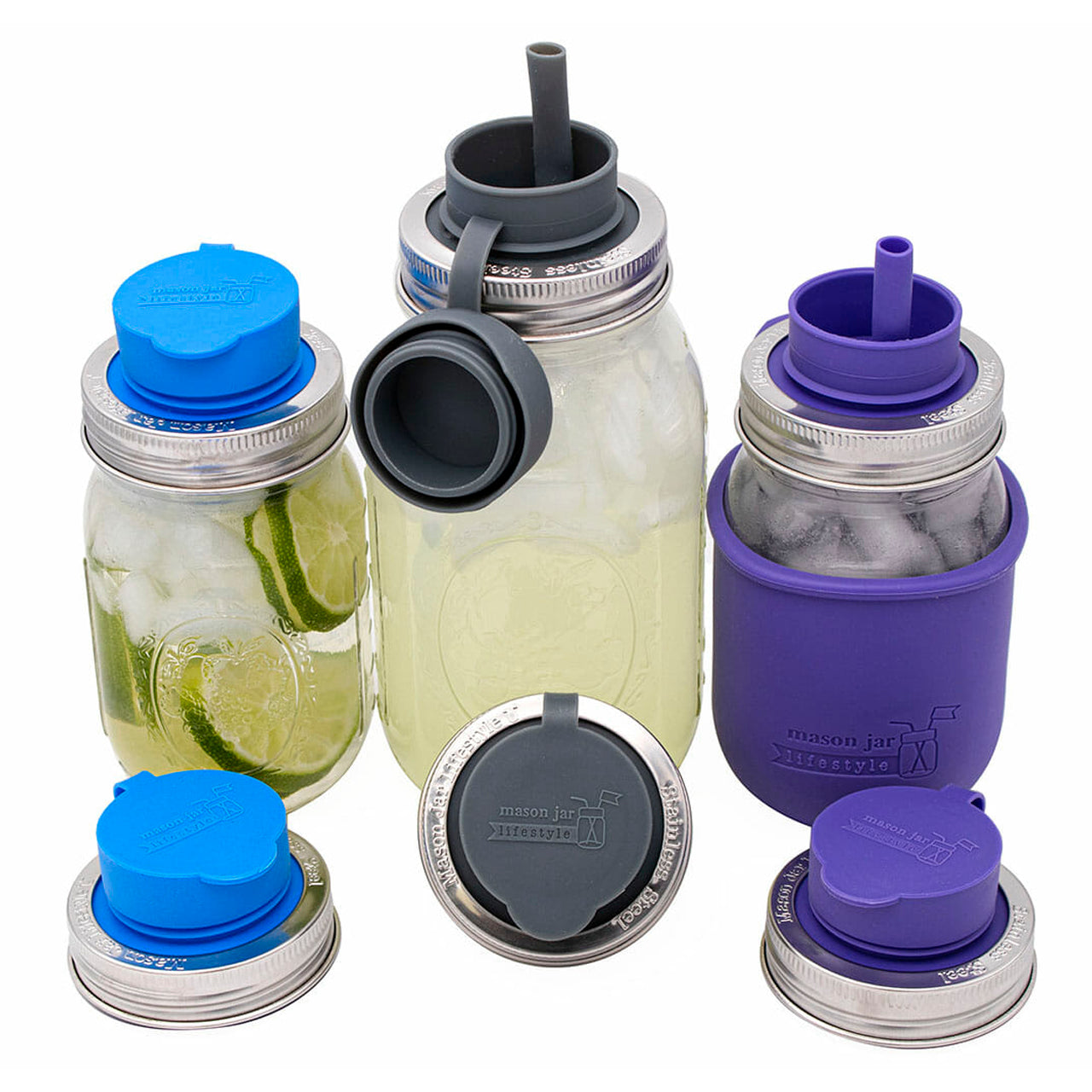 Three regular mouth Mason jars with silicone sippy lids on them, open, and showing off the double layer silicone seal, the pop up silicone straw, the strap that holds on the top lid, and the stainless steel band that keeps the whole thing on the jar.