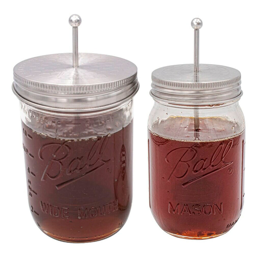 Stainless steel honey dipper lids for Mason jars, on a regular and wide mouth pint Mason jar.