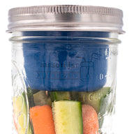 wide mouth deep blue silicone divider cup with stainless steel storage lid on 16oz wide mouth pint jar with carrots and veggies