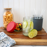 Mason jars with silicone straws, and plastic storage lids, and bamboo storage lids.