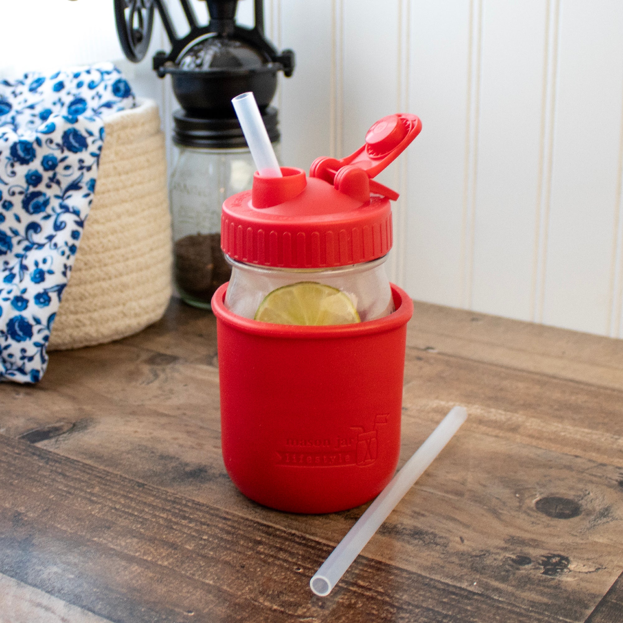 Medium silicone straw in regular mouth 16oz Mason jar, with cherry red pour & store and silicone sleeve.