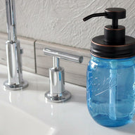 Oil rubbed bronze soap pump dispenser lid kit on blue Ball Mason pint jar on sink