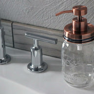 Vintage copper soap pump dispenser lid kit on Ball Mason pint jar on sink