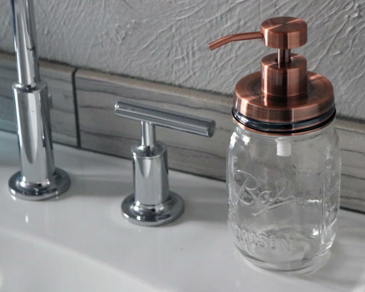 Vintage copper soap pump dispenser lid kit on Ball Mason pint jar on sink