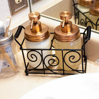 Rose gold soap pumps on pint Mason jars in a swirl caddy.