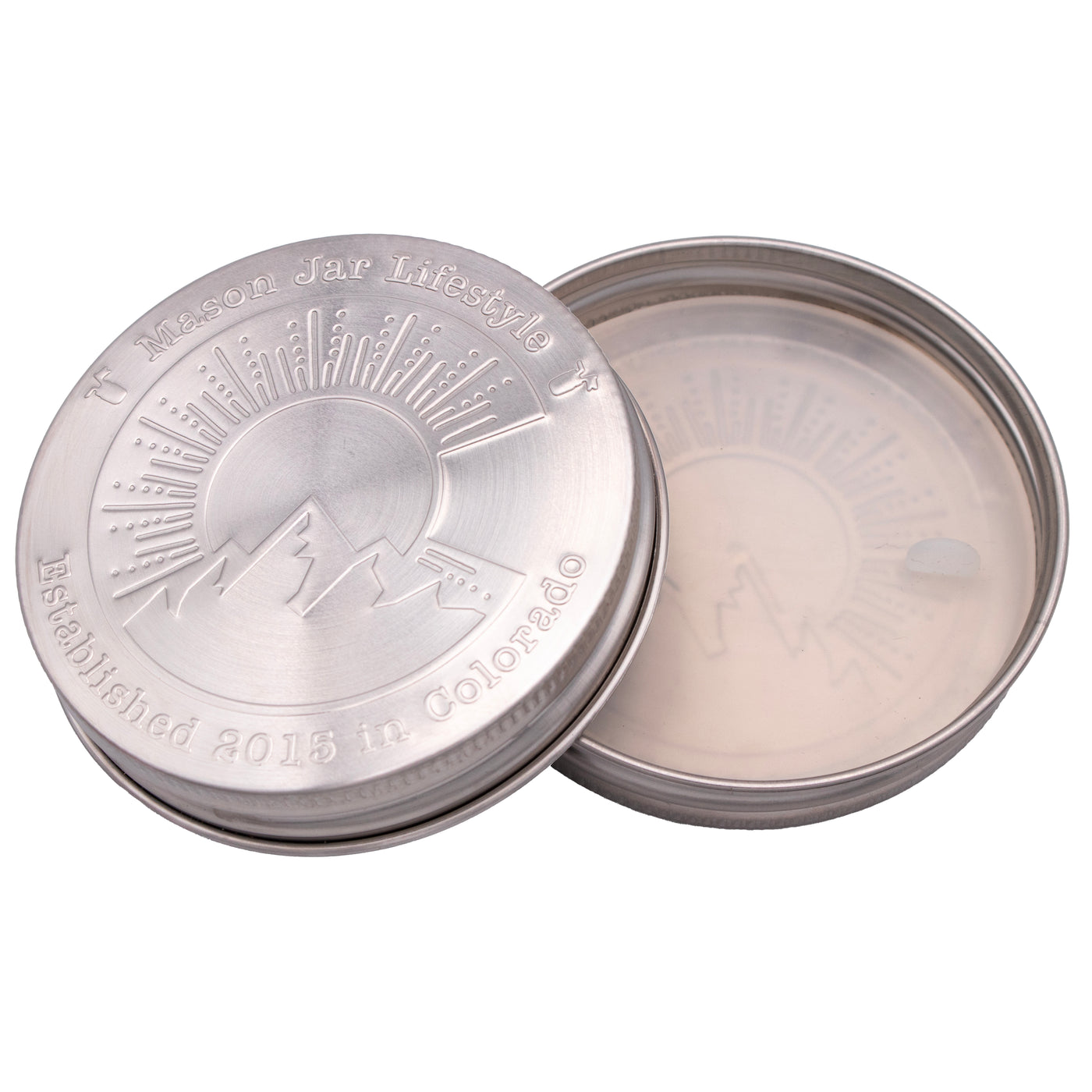 Two Colorado lids, one flipped over so you can see the silicone lid liner on the inside.