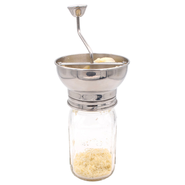 Stainless steel food mill on a wide mouth Mason jar.