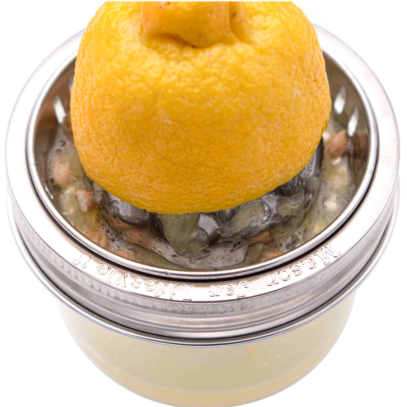 https://masonjarlifestyle.com/cdn/shop/files/mason-jar-lifestyle-stainless-steel-juicer-juicing-lid-logo-wide-mouth-8oz-kerr-lemon-in-use.jpg?v=1698867443&width=1400