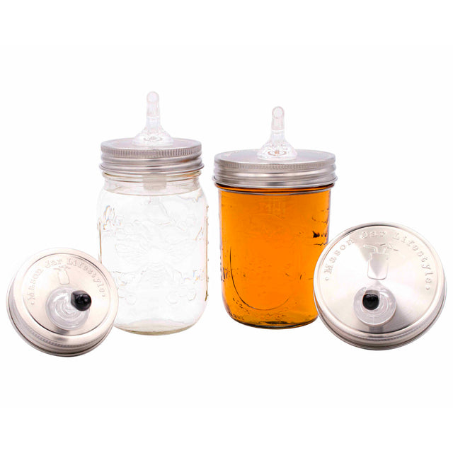 Wide mouth and regular mouth liquor pour spout lids on Mason jars.