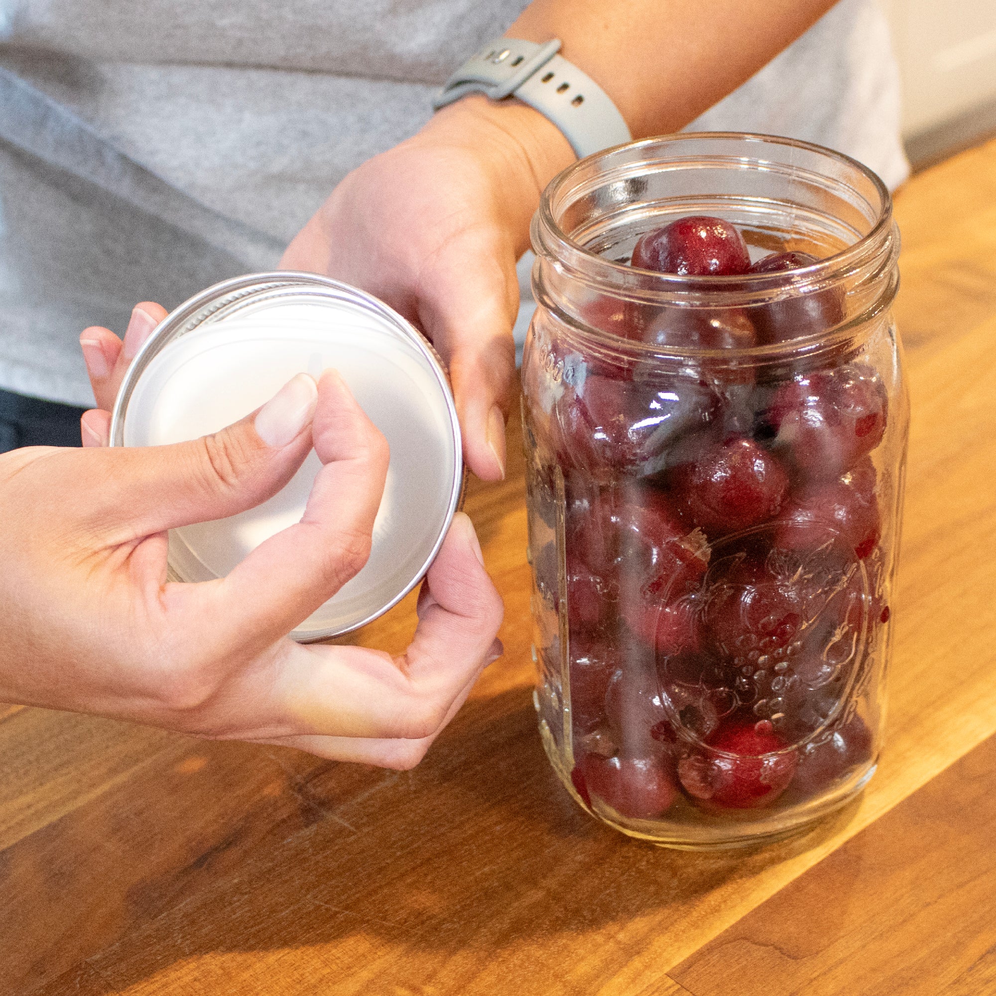 Showing how the silicone lid liner is removed from the lid, by the small silicone tab facing the bottom of the jar.