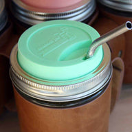 Thin bent stainless steel straw for pint Mason jars with mint green silicone drinking lid