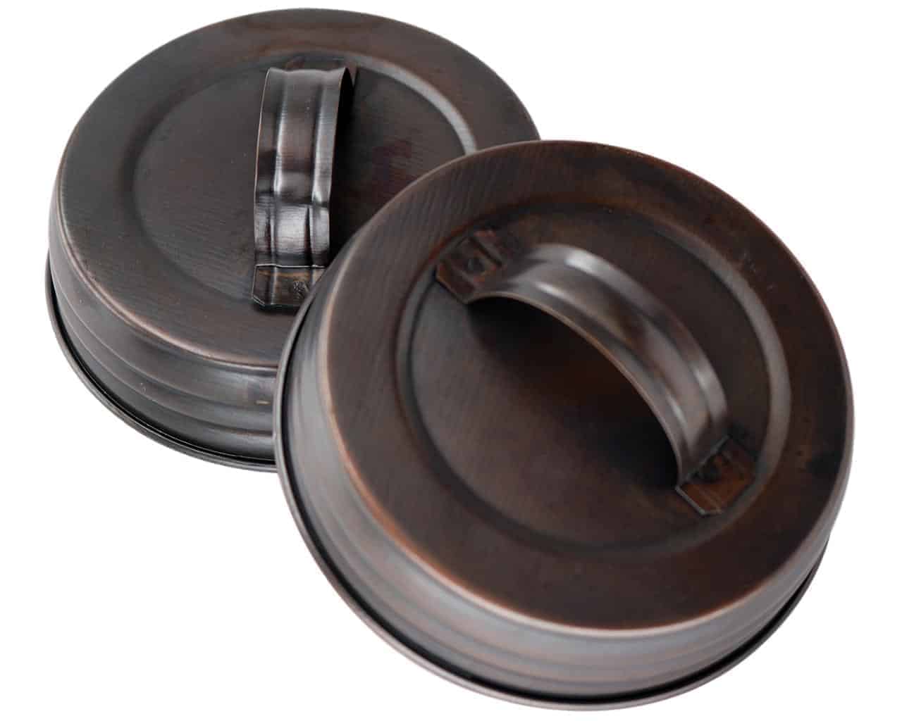 https://masonjarlifestyle.com/cdn/shop/files/mjl-antique-copper-oil-rubbed-bronze-handle-canister-lid-wide-mouth-mason-jars.jpg?v=1695767127&width=1280