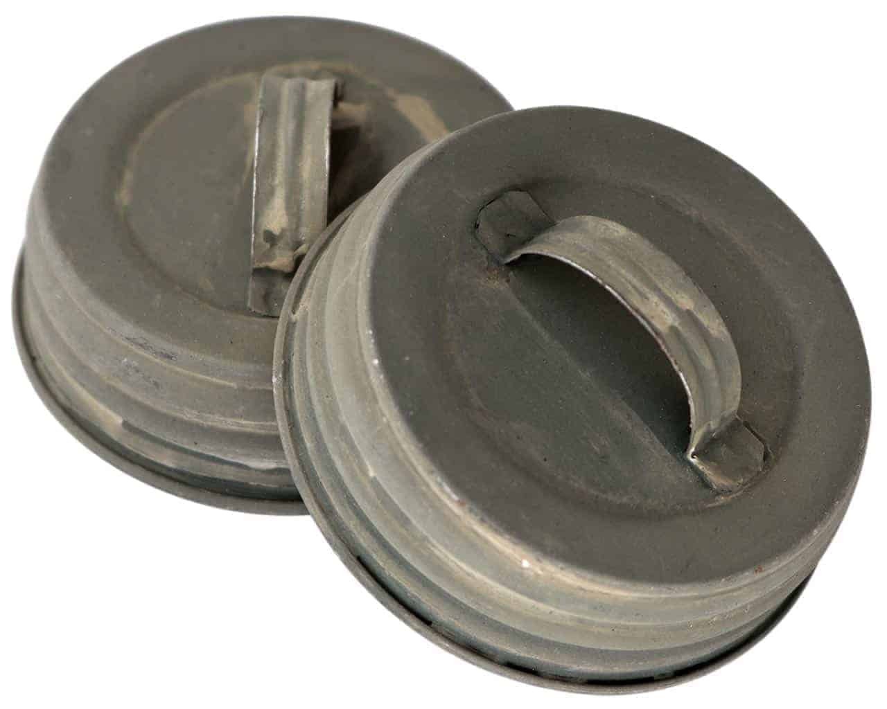 https://masonjarlifestyle.com/cdn/shop/files/mjl-antique-zinc-gray-barn-roof-handle-canister-lid-regular-mouth-mason-jars.jpg?v=1695767018&width=1280