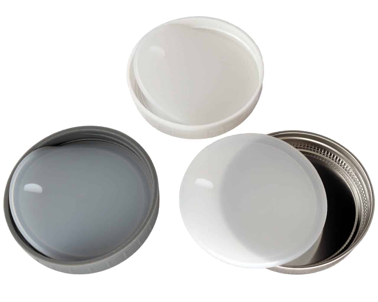 Platinum silicone lid liners with tabs in three different types of wide mouth lids. Leak proof and air tight. Use with a band as a lid, or as a liner inside other lids.