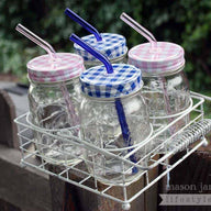 Carrying caddy for 4 pint jars with pink and blue glass straws and gingham lids