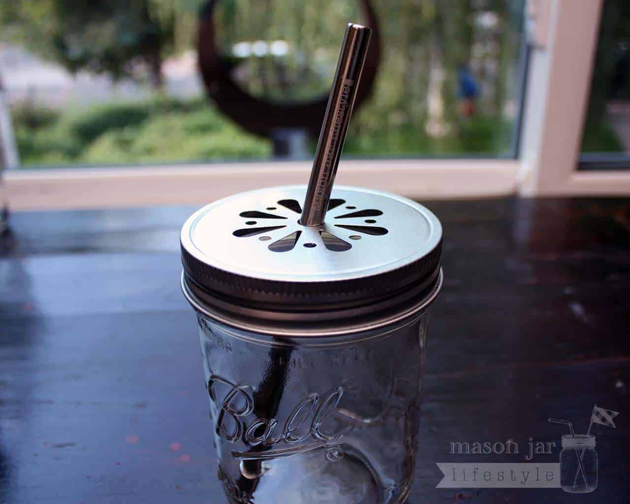Safer rounded end stainless steel straw in wide mouth daisy lid on Ball pint jar