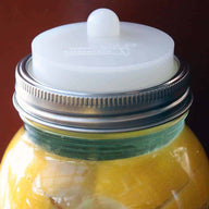 Clear silicone fermentation valve lid with Moroccan preserved lemons and tempered glass fermentation weight